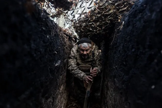 A Ukrainian soldier walks through a trench at his infantry position in the direction of Lugansk Oblast as Russia and Ukraine war continues in Ukraine on November 14, 2023. (Photo by Diego Herrera Carcedo/Anadolu via Getty Images)