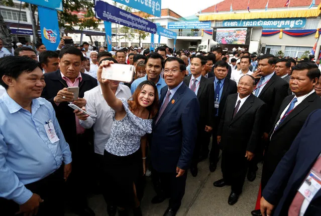 Supporters take a selfie with President of the Cambodian People's Party (CPP) and Prime Minister Hun Sen (C) and CPP Honorary President and President of the National Assembly Heng Samrin (center R) after a ceremony at the party headquarters to mark the 38th anniversary of the toppling of Pol Pot's Khmer Rouge regime in Phnom Penh, January 7, 2017. (Photo by Samrang Pring/Reuters)