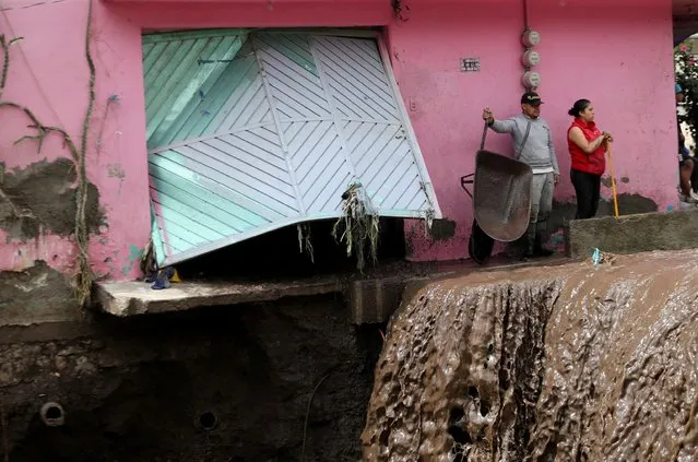 People look at the damage caused by heavy rainfall in the municipality of Ecatepec, that left two persons missing and damaged cars and infrastructure, in the outskirts of Mexico City, Mexico, September 7, 2021. (Photo by Edgard Garrido/Reuters)
