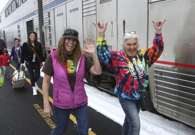 Patricia Bailey, center, and Annette Saba, right, celebrate as they disembark an Amtrak passenger train in Eugene, Ore. Tuesday, February 26, 2019.  The train traveling from Seattle to Los Angeles with 183 passengers got stranded in the snowy mountains of Oregon for at least 36 hours, putting a strain on passengers as food, patience and even diapers ran short. (Photo by Chris Pietsch/AP Photo)
