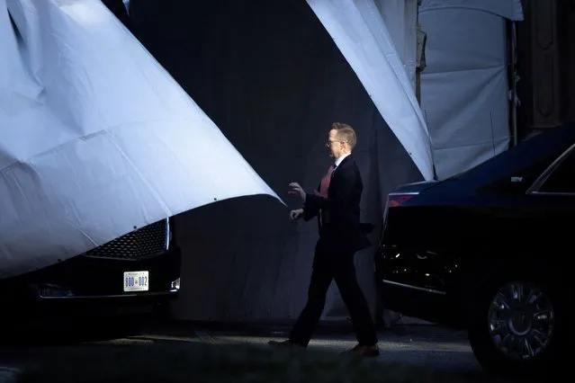 A U.S. Secret Service agent attempts to grasp a tent curtain housing “The Beast” presidential limousine, outside the Sheraton Downtown Columbia hotel in Columbia, South Carolina, U.S., January 28, 2024. (Photo by Tom Brenner/Reuters)