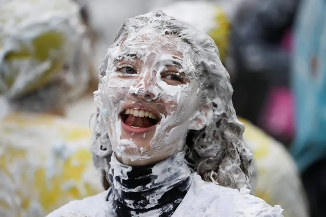 A student from St Andrews University is covered in foam as she takes part in the traditional “Raisin Weekend” in the Lower College Lawn, at St Andrews in Scotland, Britain on October 18, 2021. (Photo by Russell Cheyne/Reuters)