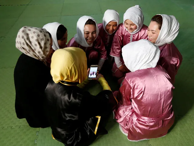 Students of the Shaolin Wushu club chat before an exercise in Kabul, Afghanistan January 19, 2017. (Photo by Mohammad Ismail/Reuters)