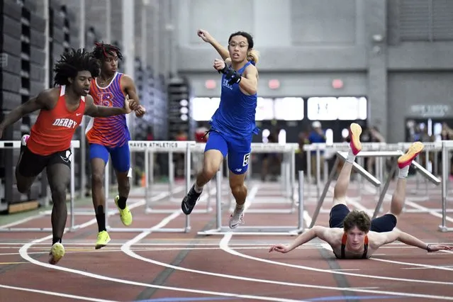 Derby's Byron MacLean, left, edges out Hall's Joe Nham in the boys 55-meter hurdles at the CIAC State Open indoor track championships at the Floyd Little Athletic Center in New Haven, Saturday, February 17, 2024. Lyman Hall's Owen Rich, right, falls after taking down the final hurdle. (Photo by Cloe Poisson/Hartford Courant via AP Photo)