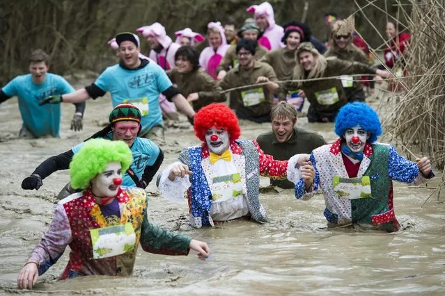Costumed participants of the “Barjot Run”, a fun run with different obstacles run through the mud in Biere, Switzerland, 09 April 2016. Over 1500 persons took part in this run with over 05 or 09 kilometers and 29 obstacles to cross. (Photo by Jean-Christophe Bott/EPA)