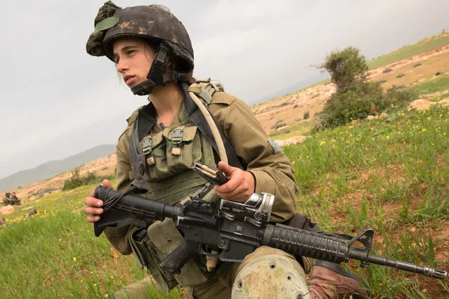 An Israeli soldier from the mixed-gender Lions of the Jordan battalion, under the Kfir Brigade, takes part in a last training before being assigned their posting, on February 28, 2017, near the West Bank village of Bardale, east of Jenin. (Photo by Jack Guez/AFP Photo)