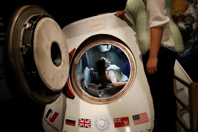 A woman wearing a prototype of Stemrad's new protective vest, Astrorad, sits inside Russian spacecraft, Excalibur-Almaz Space Capsule, during a demonstration for Reuters, at Madatech, National Museum of Science Technology and Space in Haifa, Israel February 23, 2017. (Photo by Amir Cohen/Reuters)