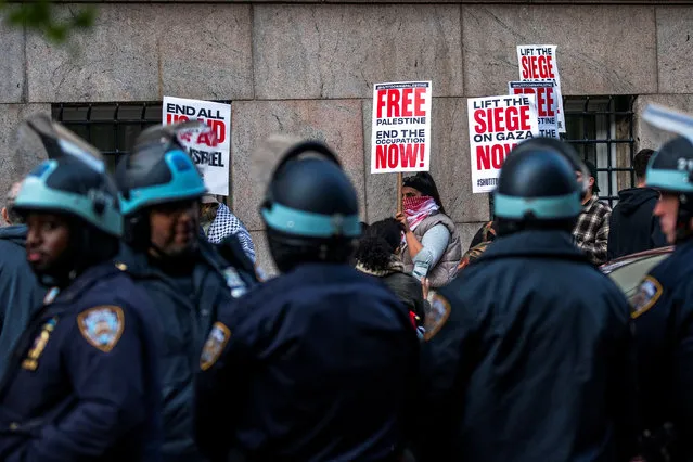 New York Police Officers keep an eye on protesters as they demonstrate outside Columbia University, as the protest encampment continues in support of Palestinians, amid ongoing conflict between Israel and the Palestinian Islamist group Hamas, in New York City, April 23, 2024. (Photo by Eduardo Munoz/Reuters)