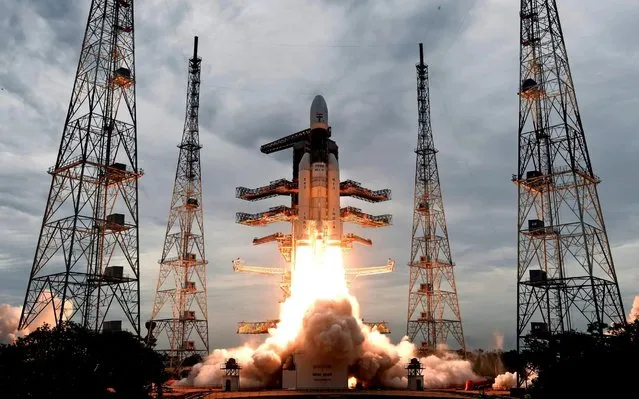 This photo released by the Indian Space Research Organization (ISRO) shows its Geosynchronous Satellite launch Vehicle (GSLV) MkIII carrying Chandrayaan-2 lift off from Satish Dhawan Space center in Sriharikota, India, Monday, July 22, 2019. India successfully launched an unmanned spacecraft to the far side of the moon on Monday, a week after aborting the mission due to a technical problem. (Photo by Indian Space Research Organization via AP Photo)