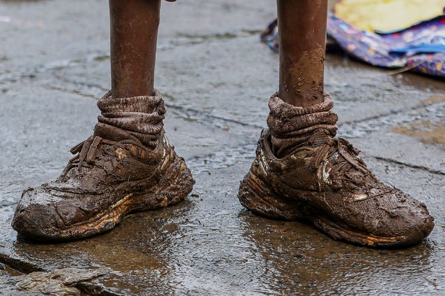 A displaced person taking shelter at a local school stands with mud-soaked footwear, a day after the Gitathuru river overflowed and broke its banks due to heavy rainfall damaging their surrounding neighborhoods, in the Ngondo village, in Mathare, Nairobi, Kenya, 25 April 2024. According to the Kenya Red Cross Society, the floodings left at least 32 dead, 15 injured and at least 103,485 people have been affected by the March-May long rains that continue to rise, including 40,265 people displaced, as of 18 April 2024. Kenya's meteorological department predicts more heavy rainfall this week, as floods continue to destroy properties in various parts of the country. (Photo by Daniel Irungu/EPA/EFE/Rex Features/Shutterstock)