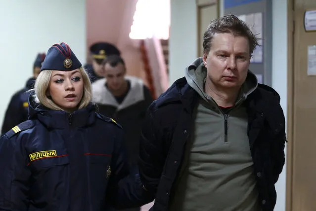 Activists who were detained at a rally that marked the 99th anniversary of the proclamation of the Belarusian People's Republic and the denouncement of a new tax on people not in full-time employment, are escorted by police upon their arrival for a court hearing in Minsk, Belarus March 27, 2017. (Photo by Vasily Fedosenko/Reuters)