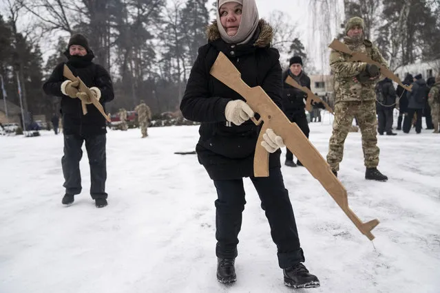 Rumiya Romanenko, 59, trains with a wooden rifle during a training session at an abandoned youth center on February 5, 2022 in the outskirts of Kyiv, Ukraine. (Photo by Michael Robinson Chavez/The Washington Post)
