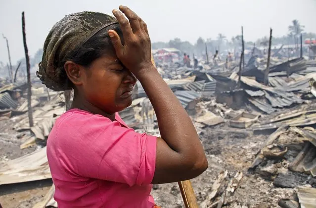 Rohingya woman cries near after a fire accident at a Baw Du Ba Muslim (Rohingya) internally displaced person (IDPs) camp near Sittwe, Rakhine State, western Myanmar, 03 May 2016. The fire broke out in the morning of 03 May 2016 at Rohingya IDPs camp which burned down 55 buildings, each with 8 rooms, making 1744 IDPs from 435 households homeless. (Photo by Nyunt Win/EPA)