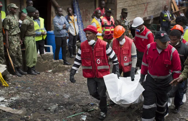 Kenyan Red Cross workers carry away a body from the site of last week's building collapse, in the Huruma neighborhood of Nairobi, Kenya, Friday, May 6, 2016. (Photo by Ben Curtis/AP Photo)