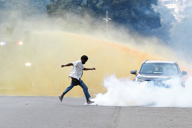 A person reacts near smoke as demonstrators gather during a demonstration against Kenya's proposed finance bill 2024/2025 in Nairobi, Kenya, on June 25, 2024. (Photo by Monicah Mwangi/Reuters)