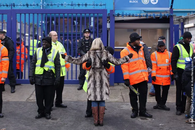 Football fans are searched before entering the Loftus Road stadium
