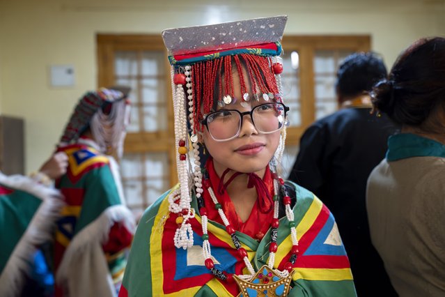 Tsering Dolma, a school girl, gets ready to perform a traditional dance at an event to celebrate the 89th birthday of Tibetan spiritual leader the Dalai Lama at the Tsuglakhang temple in Dharamshala, India, Saturday, July 6, 2024. (Photo by Ashwini Bhatia/AP Photo)