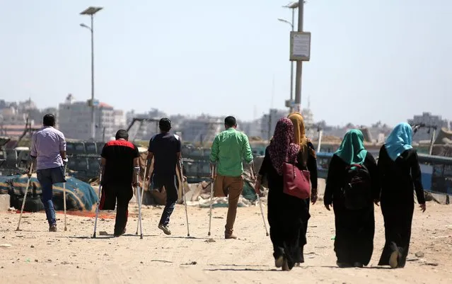 Four Palestinian youths (L) walk in the port of Gaza, on 19 May 2016. The four youths who are friends lost their lower limbs after Israeli air strikes in Al Shejaeiya market in Al Shejaeiya neighbourhood in the east of Gaza, during last war against Gaza Strip in the summer of 2014. (Photo by Mohammed Saber/EPA)