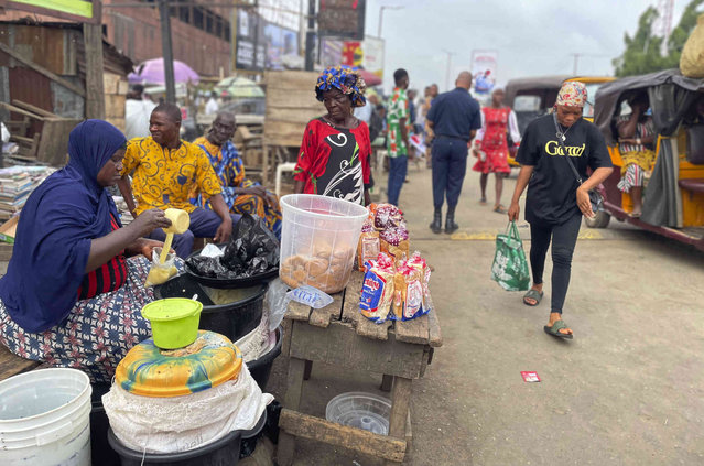 A woman sells pap on the street in Ibadan, Southwest Nigeria, Wednesday, May 29, 2024. (Photo by Sunday Alamba/AP Photo)