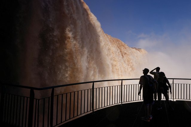 Tourist view Iguazu Falls, which are currently at full water capacity due to the rains in southern Brazil, at Iguazu Falls, Brazil, on May 7, 2024. (Photo by Kiko Sierich/Reuters)