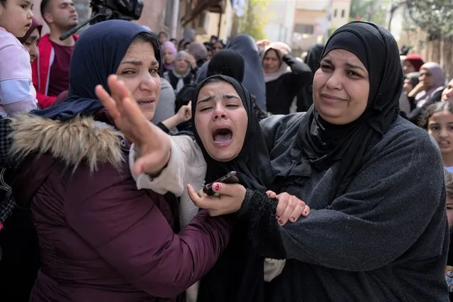 Palestinian Hadeel Abu Atiyeh, cries during the funeral of her brother Sanad Abu Atiyeh, 17, in the West Bank refugee camp of Jenin, Jenin, Thursday, March 31, 2022. (Photo by Nasser Nasser/AP Photo)