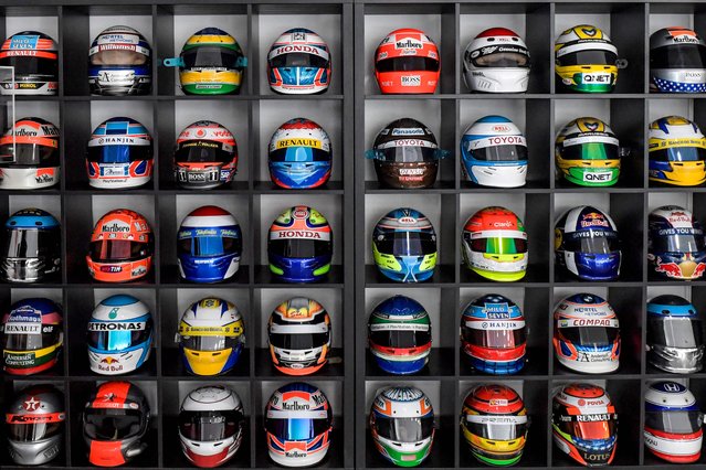 In this picture taken on March 28, 2023 racing helmets are displayed at the headquarters of Racing Force Group and its helmet factory on the outskirts of Bahrain International Circuit (BIC) in Sakhir in southern Bahrain. - The small Gulf kingdom of Bahrain is known worldwide for its prestigious Formula One competitions. In the Sakhir desert in the country's south, enthusiasm for the sport has spread to the industrial sector, with a factory locally manufacturing drivers' helmets. (Photo by Mazen Mahdi/AFP Photo)