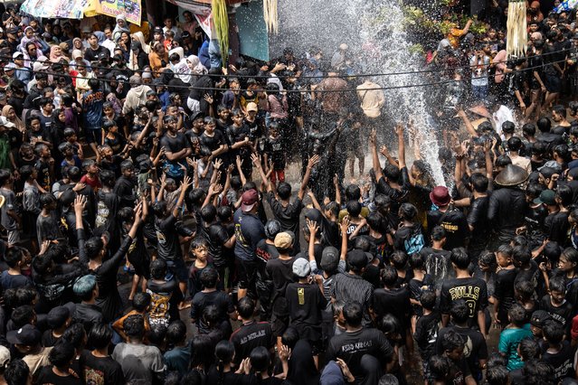 Participants gathe during Kebo-Keboan Alasmalang Festival at Alasmalang village on July 21, 2024 in Banyuwangi, Indonesia. Kebo-Keboan Alasmalang is held annually by the native Osing tribe, who dress as buffalo at the beginning of the Suro month in the Javanese calendar, to express gratitude for the abundant harvest and good fortune. (Photo by Robertus Pudyanto/Getty Images)