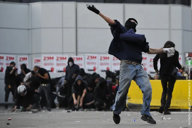 A demonstrator throws stones during heavy clashes with riot police during a 24-hour strike on March 29, 2012 in Barcelona, Spain