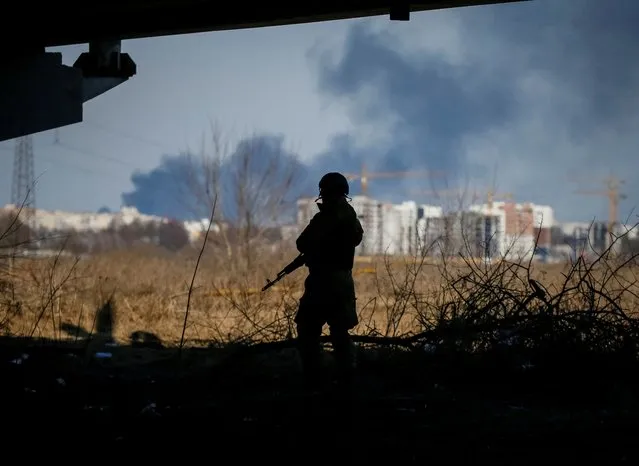 A member of the Ukrainian forces takes a position, amid Russia's invasion of Ukraine, in Irpin, Ukraine on March 12, 2022. (Photo by Gleb Garanich/Reuters)