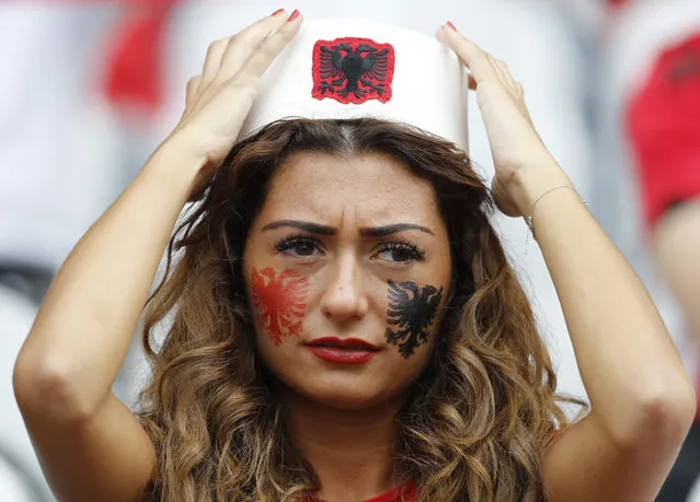 An Albania team supporter adjust her hat as she waits for the start of the Euro 2016 Group A soccer match between Albania and Switzerland, at the Bollaert stadium in Lens, France, Saturday, June 11, 2016. (Photo by Frank Augstein/AP Photo)