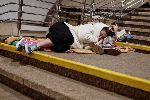 People sleep on stairs as they take shelter inside a metro station during an overnight Russian missile and drone strike, amid Russia's attack on Ukraine, in Kyiv, Ukraine on June 4, 2023. (Photo by Yan Dobronosov/Reuters)