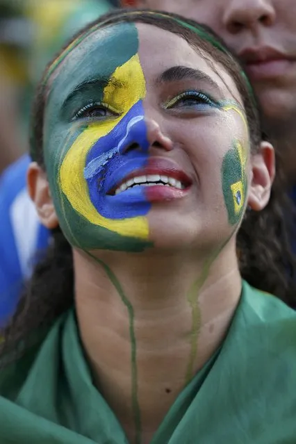 A fan of Brazil reacts while watching a broadcast of the 2014 World Cup semi-final against Germany at the Fan Fest in Brasilia, July 8, 2014. (Photo by Ueslei Marcelino/Reuters)