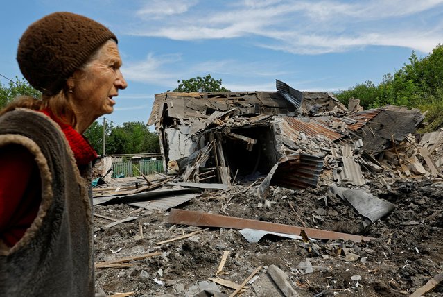 A local resident walks past a destroyed house of a woman killed during a shelling in the course of Russia-Ukraine conflict in Donetsk, Russian-controlled Ukraine on July 31, 2023. (Photo by Alexander Ermochenko/Reuters)