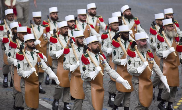 French troops of the Pionneers of the 1st Foreign Regiment march in the traditional military parade as part of the Bastille Day celebrations in Paris, France, 14 July 2014. The Bastille Day, the French National Day, is held annually on 14 July to commemorate the storming of the Bastille fortress in 1789. (Photo by Ian Langsdon/EPA)