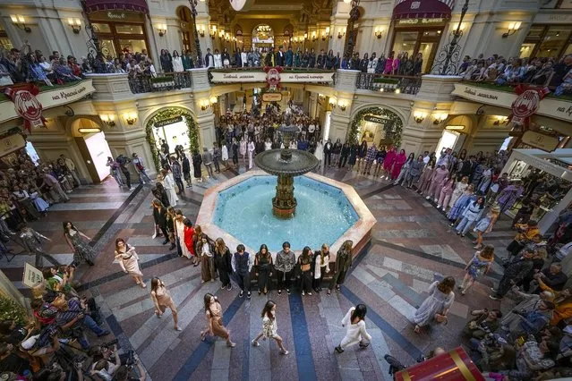 Models display the collection by a group of Russian designers inside the GUM department store with lots of boutiques closed due to sanctions during the opening of the Fashion Week in Moscow, Russia, Monday, June 20, 2022. (Photo by Alexander Zemlianichenko/AP Photo)