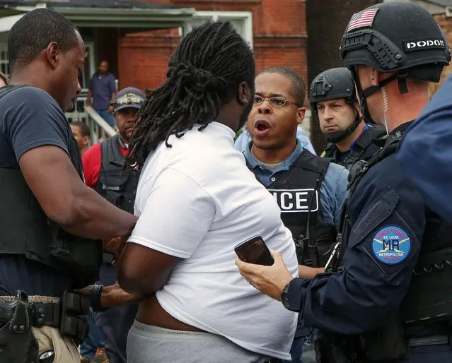 A police officer and a protester have a confrontation during an arrest after a shooting incident in St. Louis, Missouri August 19, 2015. (Photo by Lawrence Bryant/Reuters)