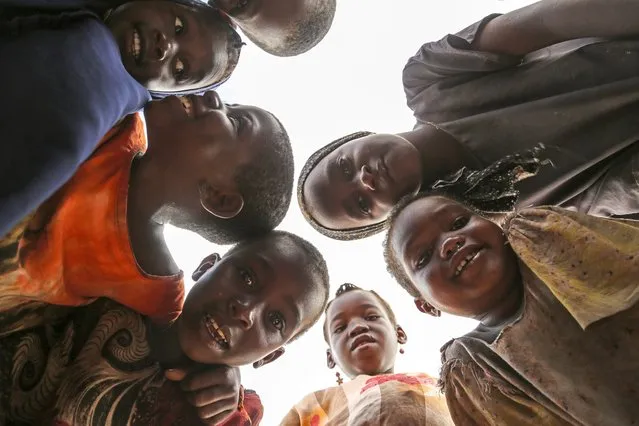 Somali children who fled drought-stricken areas play together at a makeshift camp for the displaced on the outskirts of Mogadishu, Somalia Wednesday, June 29, 2022. (Photo by Farah Abdi Warsameh/AP Photo)