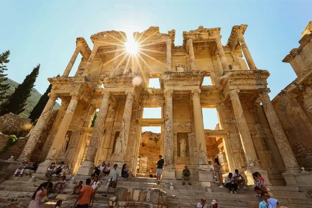Visitors stroll around the Ephesus Ancient City, on the UNESCO World Cultural Heritage List, in Izmir, Turkiye on July 02, 2022. (Photo by Mehmet Emin Menguarslan/Anadolu Agency via Getty Images)