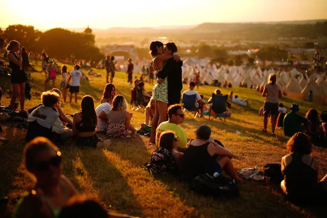 A general view of people at sunset during the Glastonbury Festival at Worthy Farm in Somerset, South West England on Wednesday, June 22, 2022. (Photo by Ben Birchall/PA Wire)