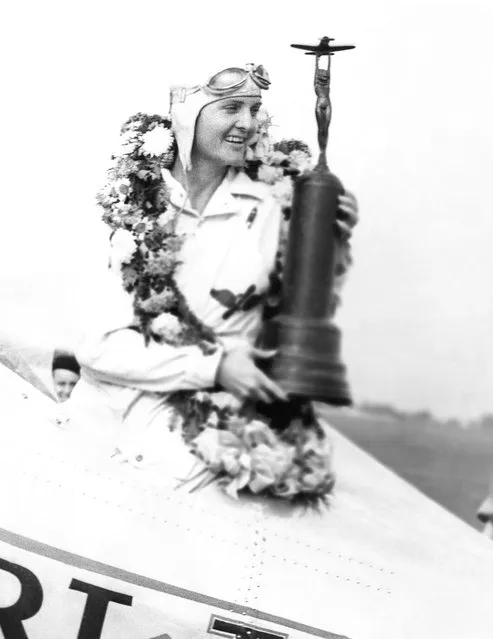 Miss Gladys O'Donnell of Long Beach, Calif., is shown in the cockpit of her plane at the national air races in Cleveland, on September 3, 1937 after she had won the Amelia Earhart memorial race, Miss O'Donnell has the trophy and wreath signifying victory. (Photo by AP Photo)