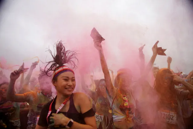 Participants are covered with color powder as they celebrate during in the Color Run in  Shanghai, China September 24, 2017. (Photo by Aly Song/Reuters)