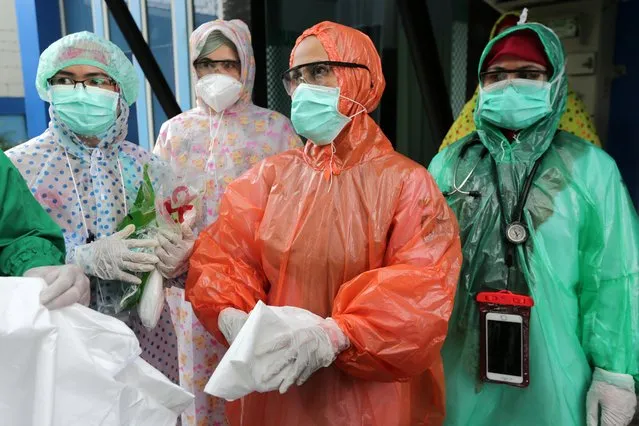 Medical workers wearing disposable raincoats as their protective suits to serve patients are pictured amid the spread of coronavirus disease (COVID-19) outbreak at a local health center in Aceh, Indonesia, April 6, 2020. (Photo by Irwansyah Putra/Antara Foto via Reuters)