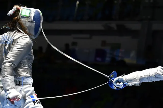 France's Charlotte Lembach (L) competes against Italy's Irene Vecchi during their womens individual sabre qualifying bout as part of the fencing event of the Rio 2016 Olympic Games, on August 8, 2016, at the Carioca Arena 3, in Rio de Janeiro. (Photo by Fabrice Coffrini/AFP Photo)