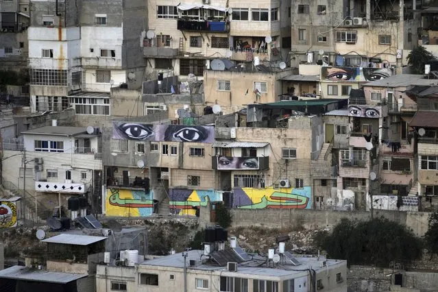 Murals that are part of the public art project “I Witness Silwan” depicting the eyes of local and international figures, including George Floyd, a Black American killed by police, top right, in the Silwan neighbourhood of east Jerusalem, Friday, August 26, 2022. (Photo by Mahmoud Illean/AP Photo)