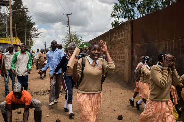 Girls from Gitanga Primary school flee after getting caught between opposition supporters and police who were clashing after Cabinet Secretary Fred Matiang'i visited the school in the Kawangware slum on October 30, 2017 in Nairobi, Kenya. Tensions remain high in Kenya after the controversial rerun election which saw pockets of violence and low voter turnout. (Photo by Andrew Renneisen/Getty Images)