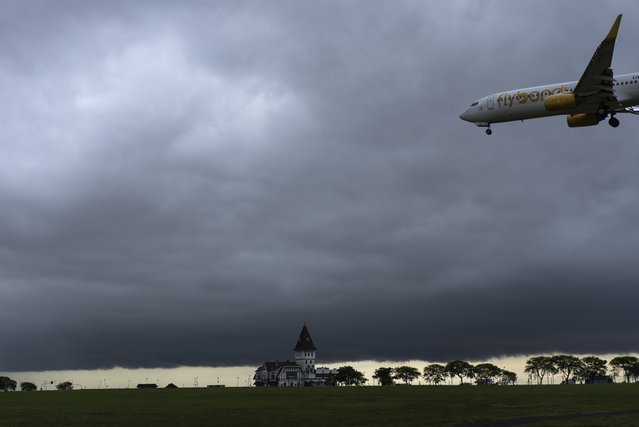 A plane arrives for landing at the Jorge Newbery airport in Buenos Aires, Argentina, early Monday, November 4, 2024. (Photo by Rodrigo Abd/AP Photo)