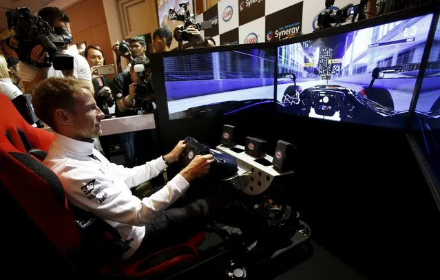 McLaren Formula One driver Jenson Button of Britain races in a virtual simulator during publicity events ahead of the Singapore F1 night race in Singapore September 16, 2015. (Photo by Edgar Su/Reuters)