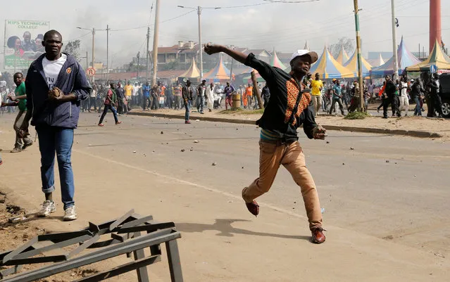 Supporters of Kenyan opposition leader Raila Odinga throw rocks during protests in Nairobi, Kenya on November 17, 2017. (Photo by Thomas Mukoya/Reuters)