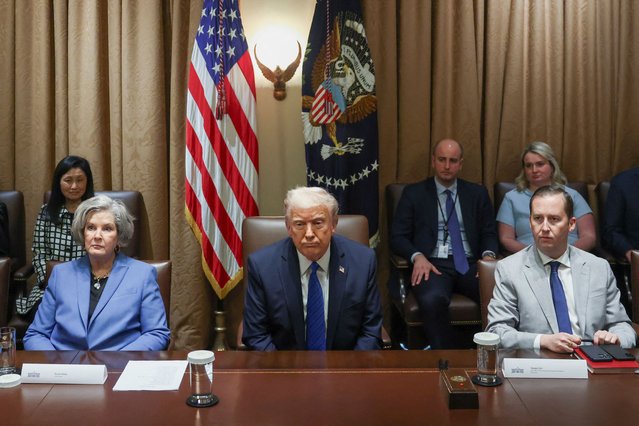 U.S. President Donald Trump reacts as  Director Presidential Personnel Office Sergio Gor and White House Chief of Staff Susie Wiles sit next to him on the day of a meeting with U.S. ambassadors at the White House in Washington on March 25, 2025. (Photo by Evelyn Hockstein/Reuters)