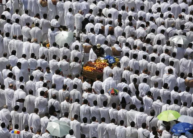 Muslim pilgrims perform prayers in Arafat during the annual haj pilgrimage, outside the holy city of Mecca September 23, 2015. (Photo by Ahmad Masood/Reuters)